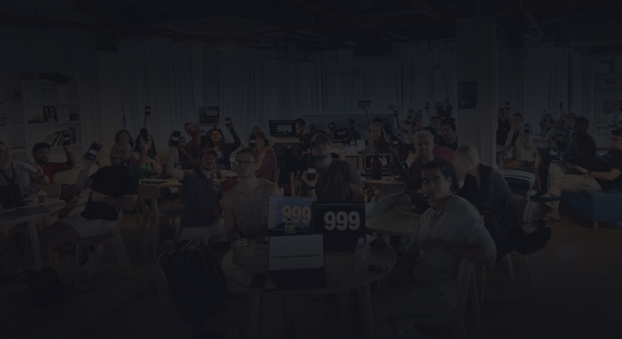 The 999 Venture Studio team holding up 999 signs in the studio